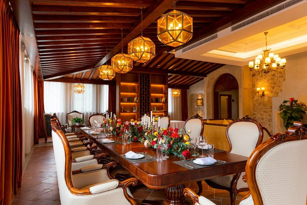 Couple enjoying private dining experience on a secluded beach at sunset