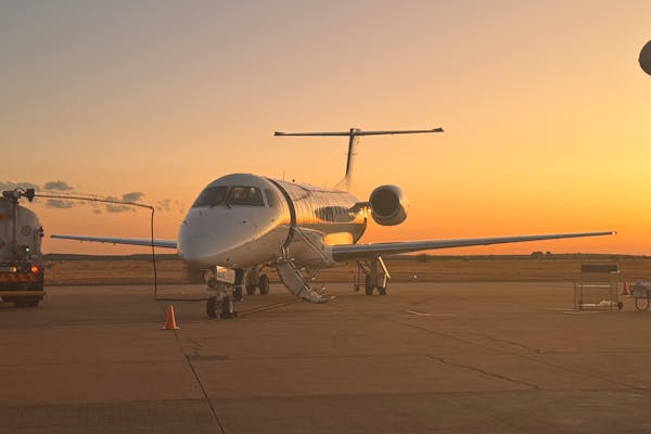 Private helicopter landing at a remote luxury mountain lodge